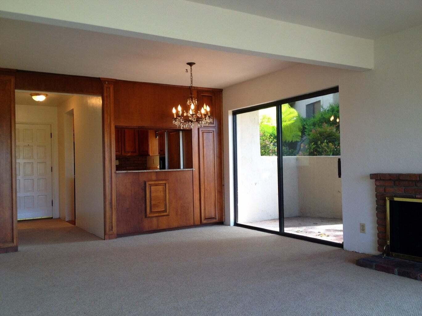 3375 Foothill Road, Unit 1011 Carpinteria, CA 93013 - Photo 5 of 6 a view of a livingroom with a fireplace window and chandelier
