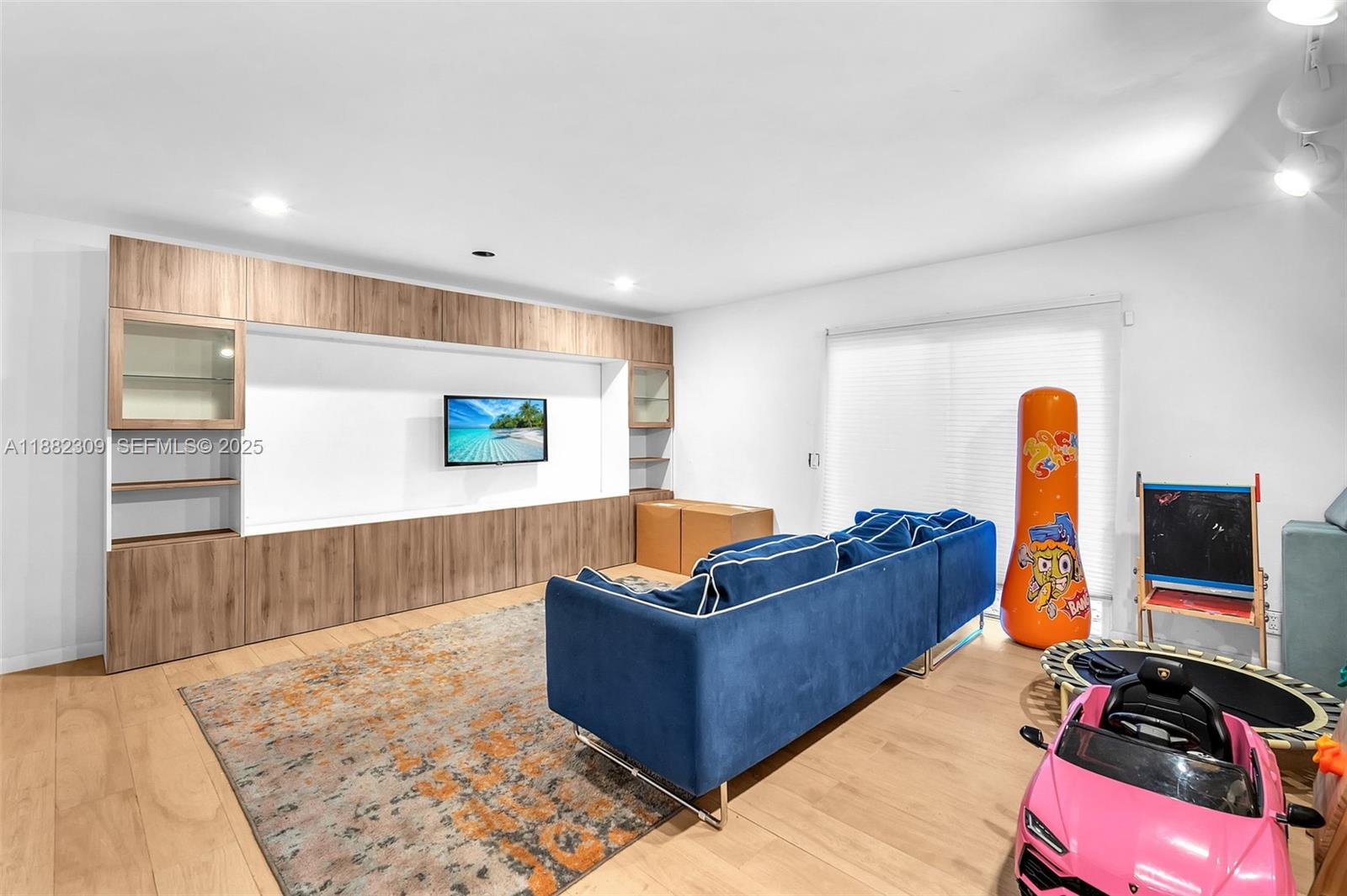 4401 Sanders Street Hollywood, FL 33021 - Photo 11 of 71 a living room with furniture and a flat screen tv