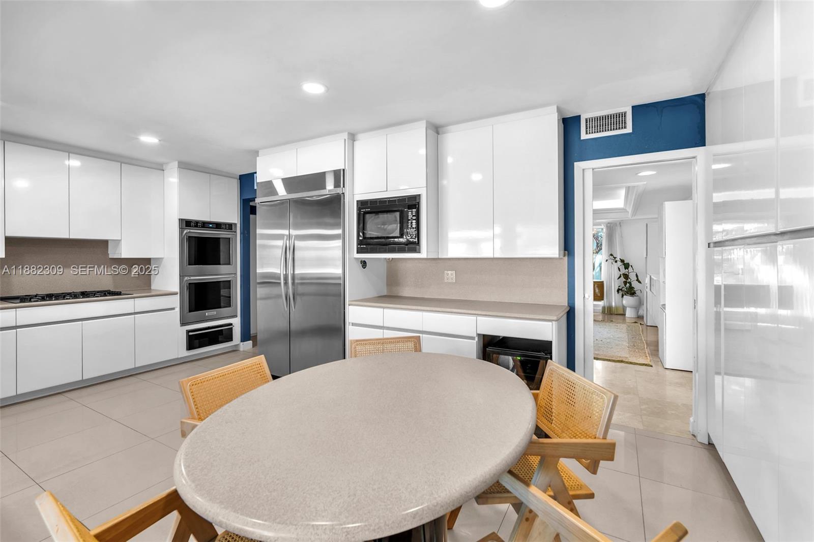 4401 Sanders Street Hollywood, FL 33021 - Photo 13 of 71 a kitchen with a refrigerator and a stove top oven