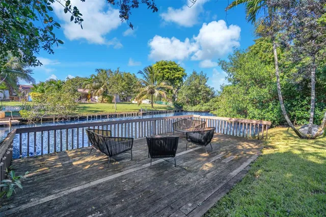 a view of a table and chairs in patio with wooden fence