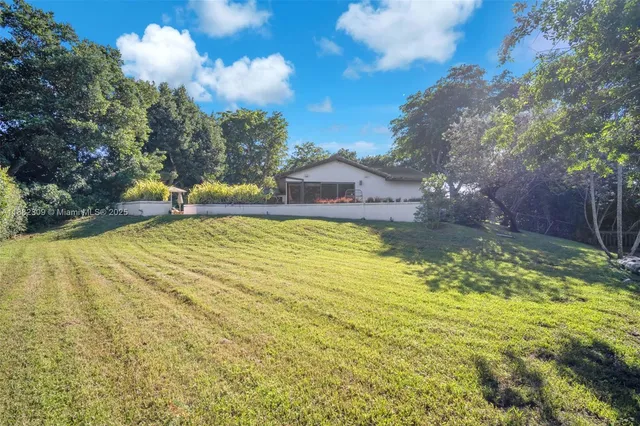 a view of a bench in the backyard