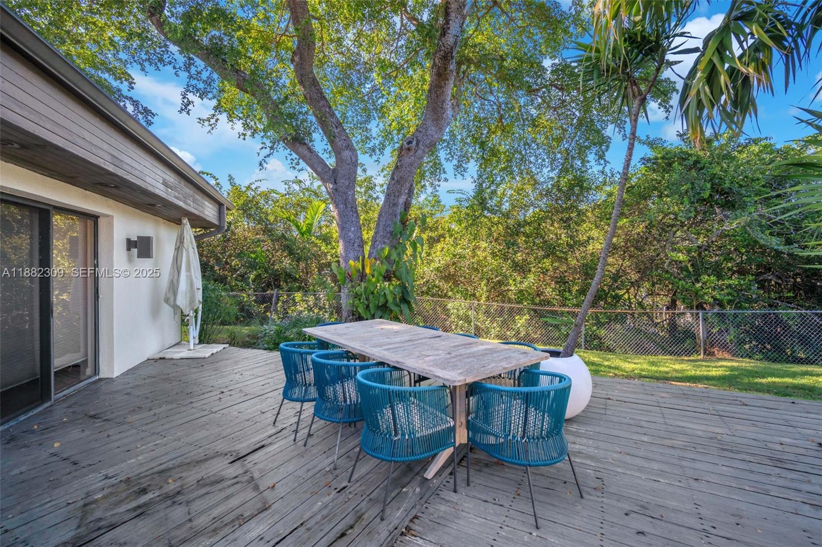 4401 Sanders Street Hollywood, FL 33021 - Photo 21 of 71 a view of a table and chairs in patio with wooden fence