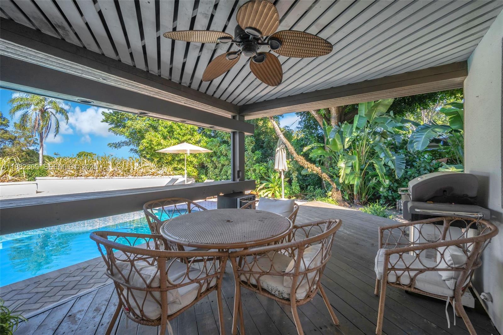 4401 Sanders Street Hollywood, FL 33021 - Photo 31 of 71 a view of a patio with a table chairs and a backyard
