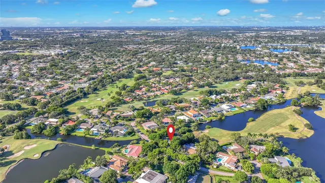 a view of a bedroom with a bed and wooden floor