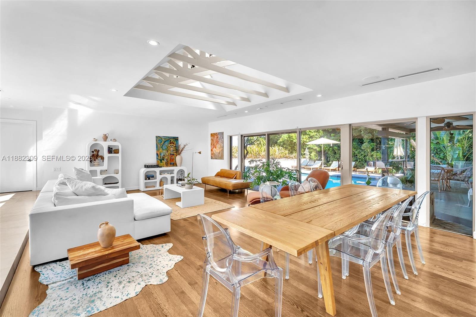 4401 Sanders Street Hollywood, FL 33021 - Photo 48 of 71 a view of a dining room with furniture wooden floor and chandelier