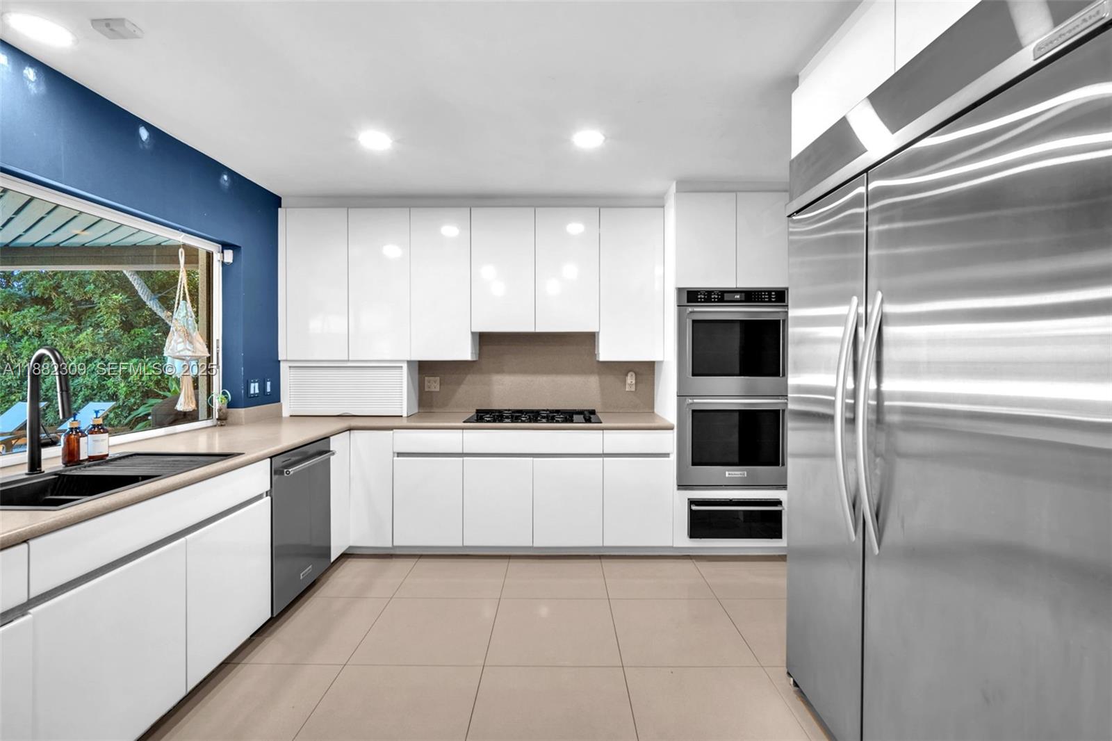 4401 Sanders Street Hollywood, FL 33021 - Photo 52 of 71 a kitchen with stainless steel appliances granite countertop a stove a sink and a refrigerator