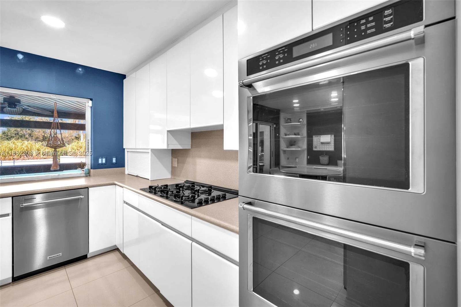 4401 Sanders Street Hollywood, FL 33021 - Photo 55 of 71 a kitchen with white cabinets and appliances