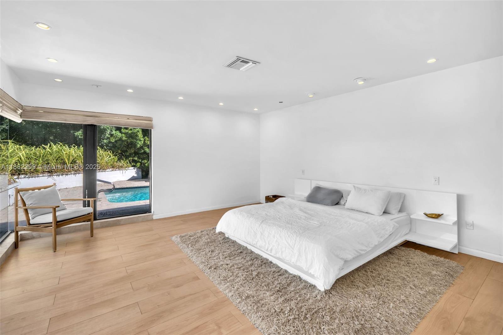 4401 Sanders Street Hollywood, FL 33021 - Photo 56 of 71 a view of a bedroom with a bed and wooden floor