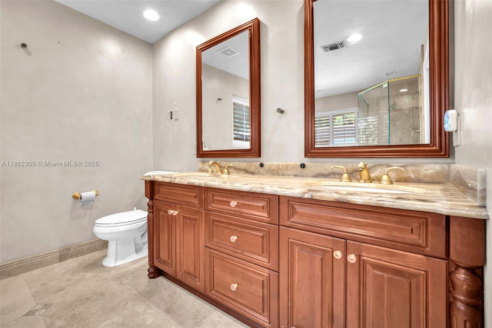 4401 Sanders Street Hollywood, FL 33021 - Photo 59 of 71 a bathroom with a granite countertop toilet sink and a mirror