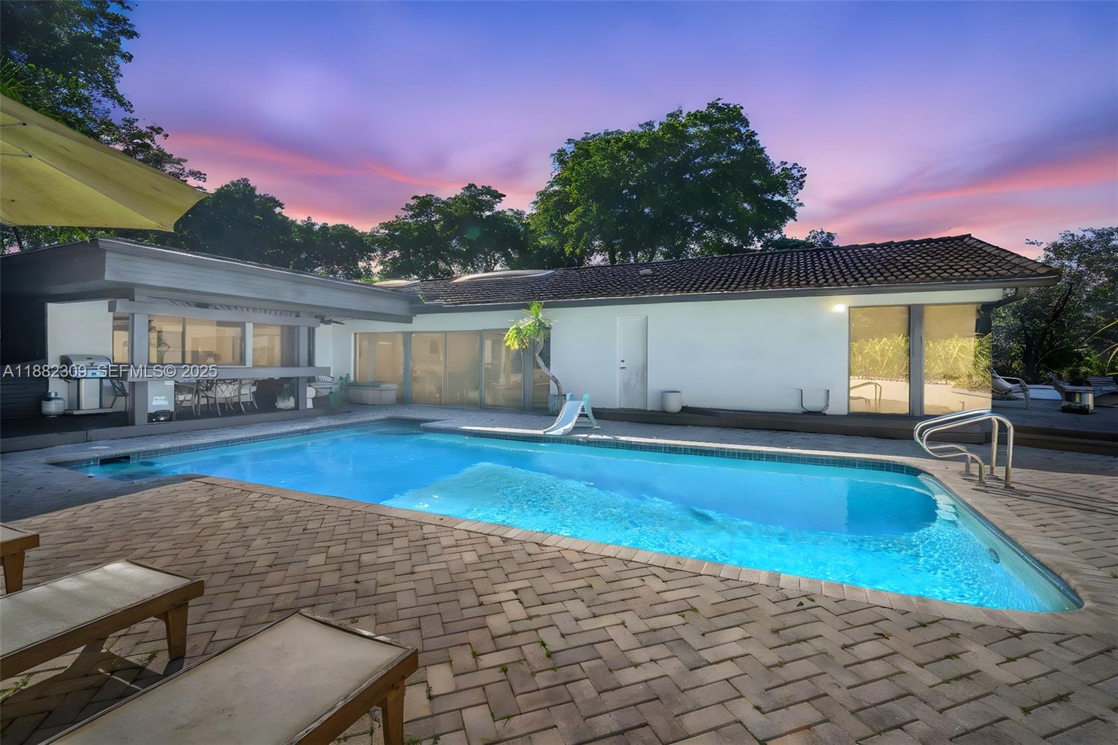 4401 Sanders Street Hollywood, FL 33021 - Photo 65 of 71 a swimming pool with outdoor seating and yard