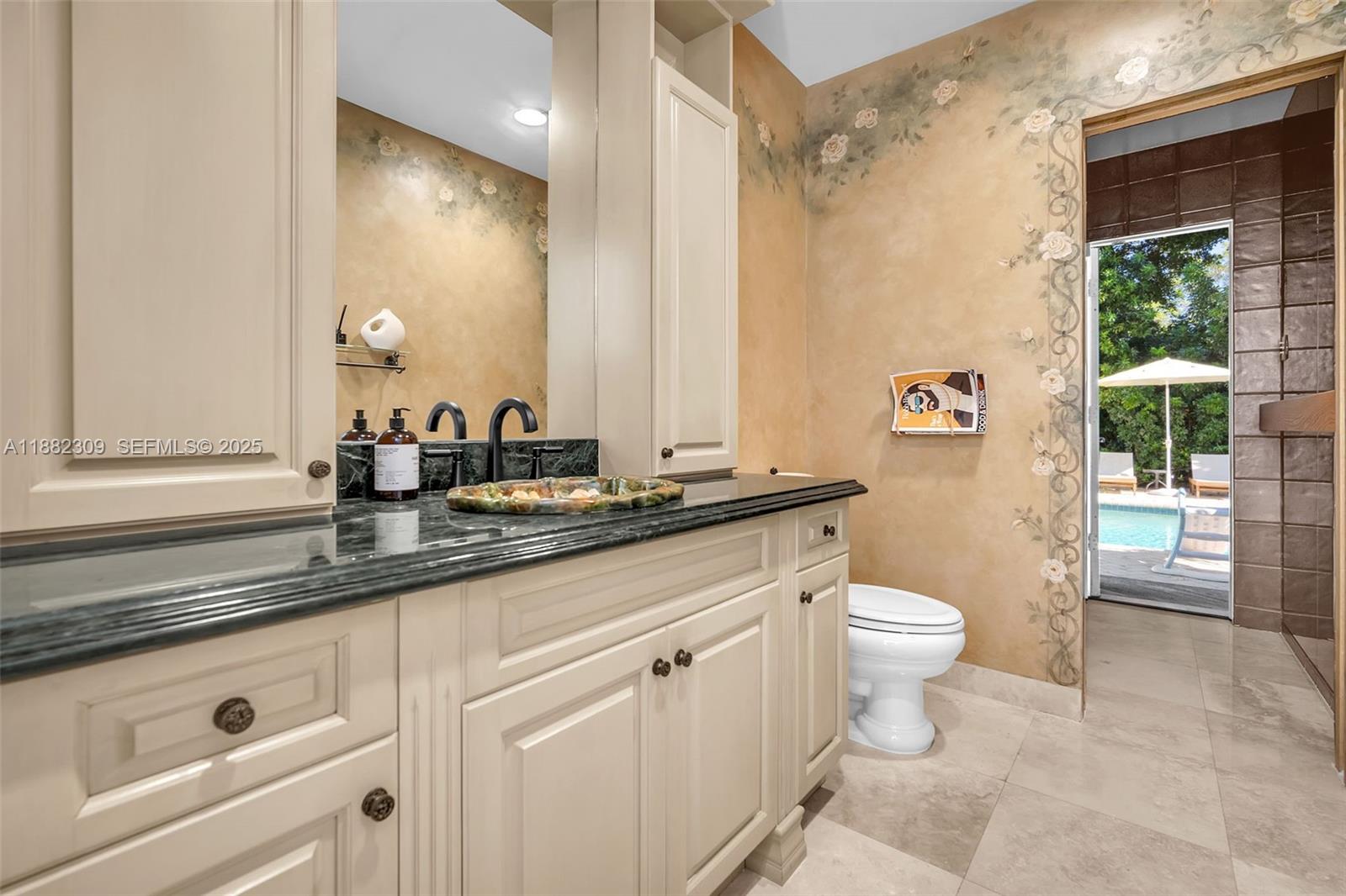 4401 Sanders Street Hollywood, FL 33021 - Photo 69 of 71 a bathroom with a granite countertop sink a toilet a mirror and shower