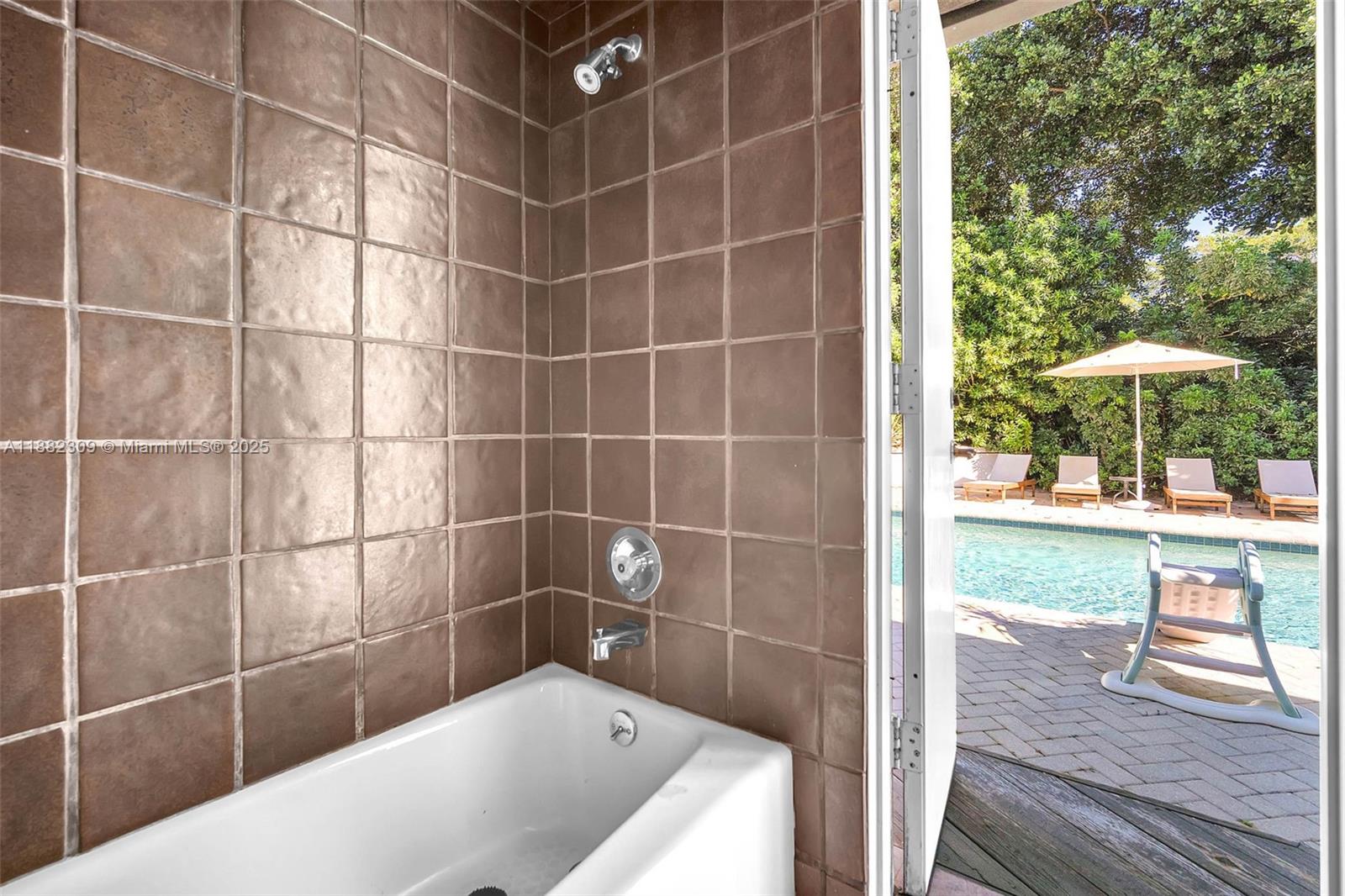 4401 Sanders Street Hollywood, FL 33021 - Photo 70 of 71 a bathroom with a bathtub and next to a window