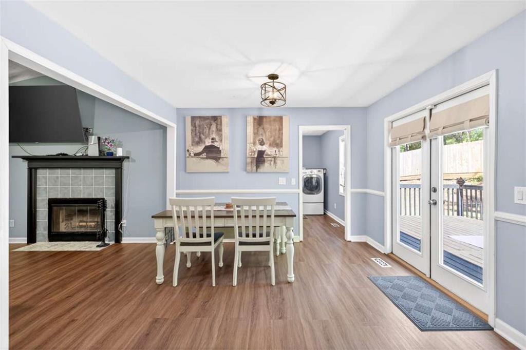 386 Ridgewood Drive Pendergrass, GA 30567 - Photo 12 of 50 a dining room with furniture a fireplace and wooden floor