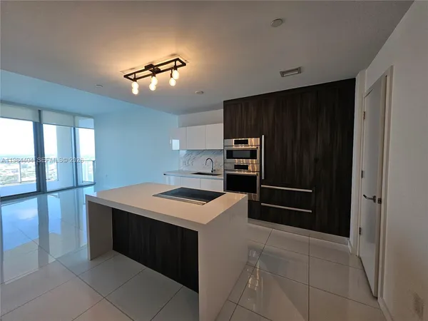 a kitchen with a stove a refrigerator and a sink
