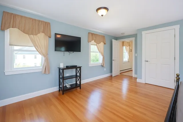 wooden floor in an empty room with a window
