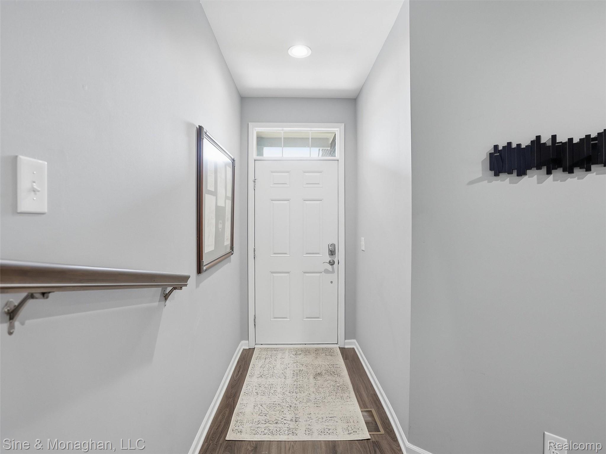 24827 Ivy Road Novi, MI 48375 - Photo 3 of 38 Entryway featuring a white paneled door with transom window, wood-finish flooring, light gray wall tones, and recessed lighting