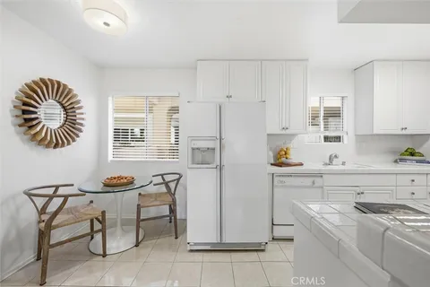 a kitchen with stainless steel appliances a stove a sink cabinets and a window
