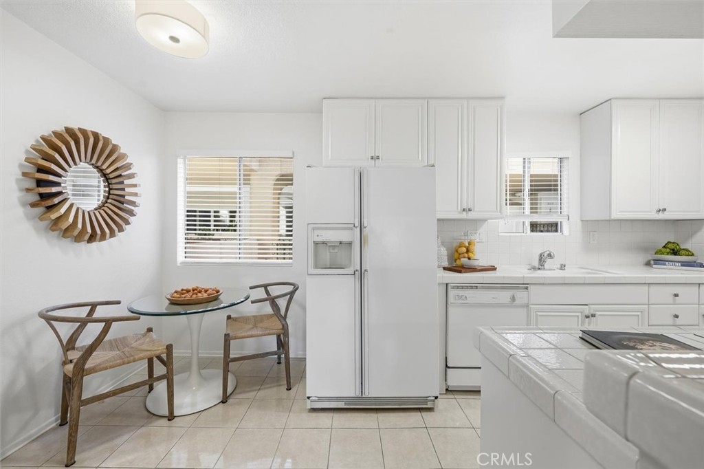 222 7th Street, Unit 202 Santa Monica, CA 90402 - Photo 14 of 41 a kitchen with stainless steel appliances a stove a sink cabinets and a window