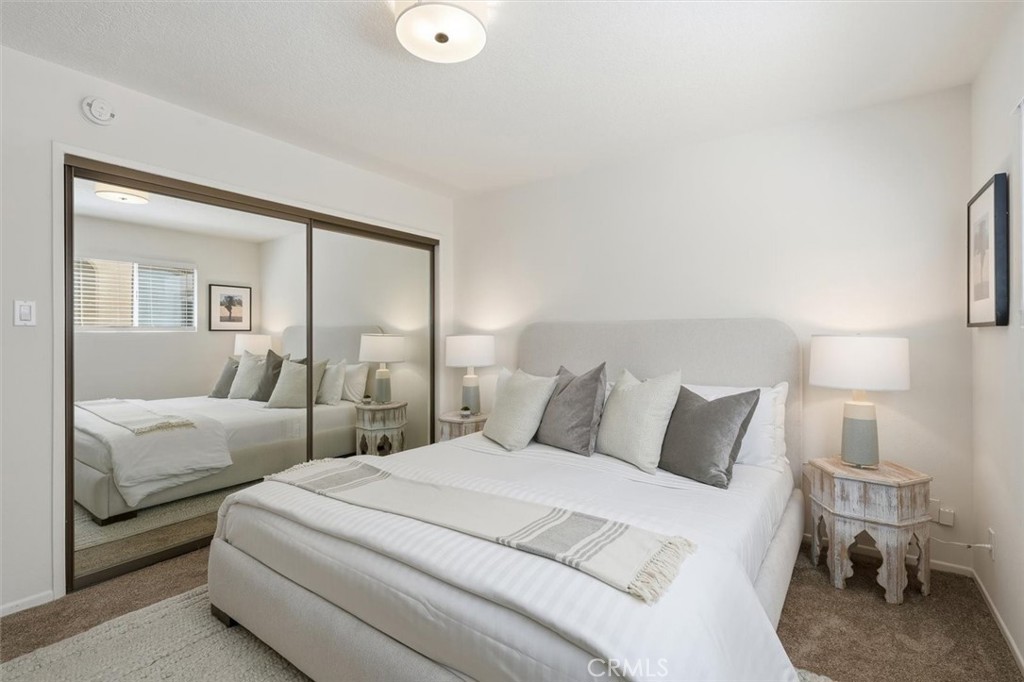 222 7th Street, Unit 202 Santa Monica, CA 90402 - Photo 20 of 41 a bedroom with a bed and a large mirror