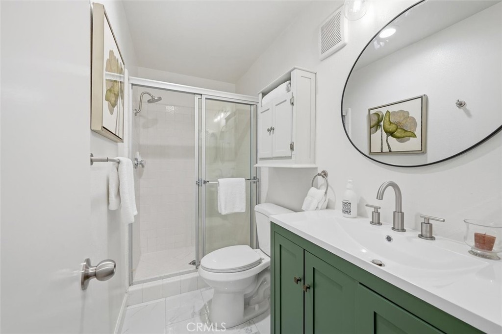 222 7th Street, Unit 202 Santa Monica, CA 90402 - Photo 23 of 41 a bathroom with a toilet sink and mirror