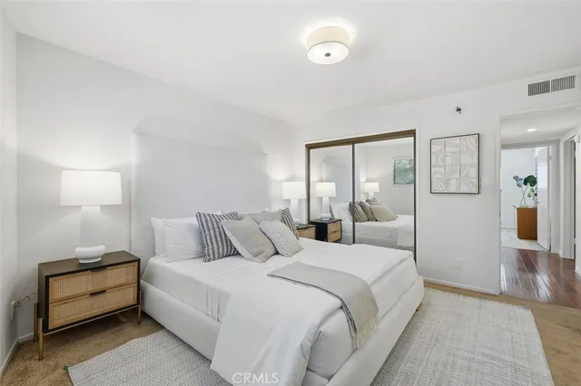 a bedroom with a bed and a couch