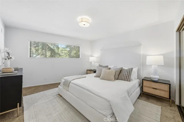 a bedroom with a bed and a night stand