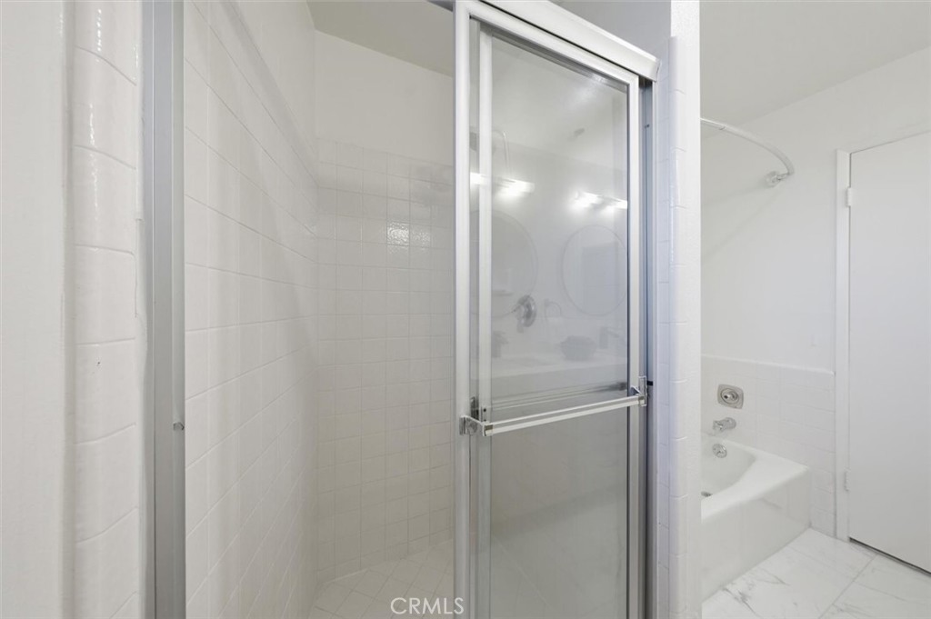 222 7th Street, Unit 202 Santa Monica, CA 90402 - Photo 30 of 41 a bathroom with a glass shower door and a bathroom