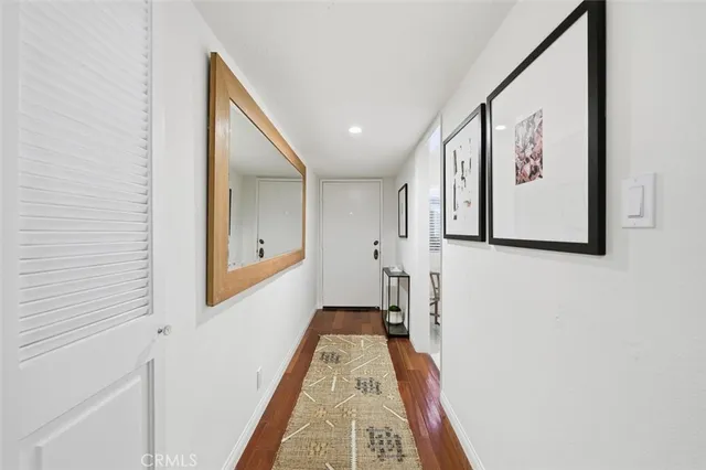a hallway with wooden floor and entryway
