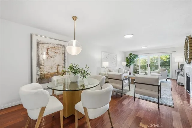 a dining room with furniture a chandelier and wooden floor