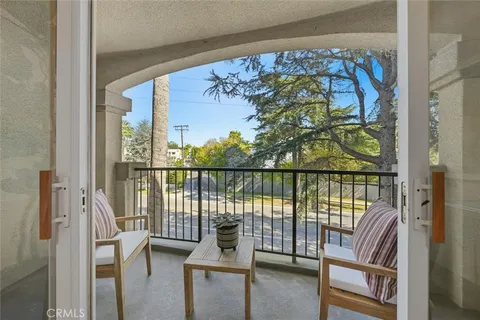 a view of a balcony with chairs