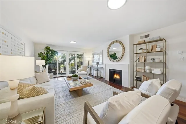 a living room with furniture a fireplace and a large window