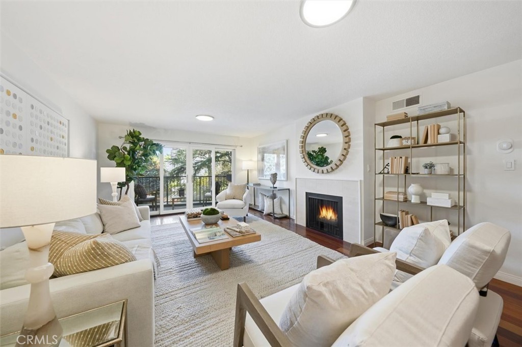 222 7th Street, Unit 202 Santa Monica, CA 90402 - Photo 8 of 41 a living room with furniture a fireplace and a large window