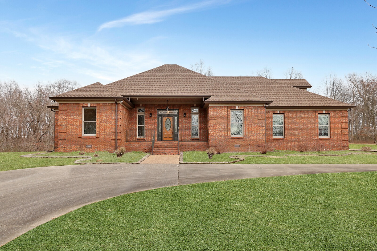 a front view of a house with a garden