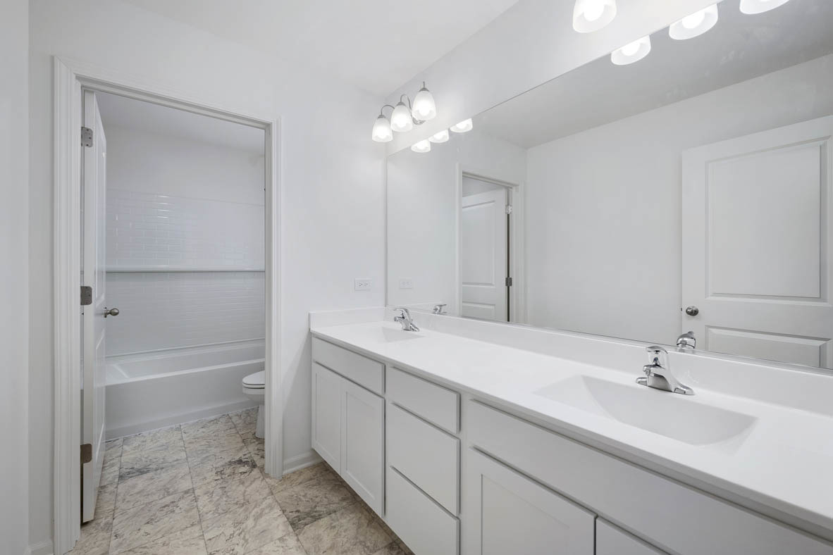 750 Kentshire Circle Elgin, IL 60124 - Photo 18 of 23 a bathroom with a double vanity sink mirror and shower