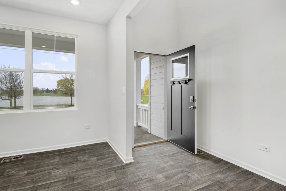 750 Kentshire Circle Elgin, IL 60124 - Photo 3 of 23 an empty room with wooden floor and windows