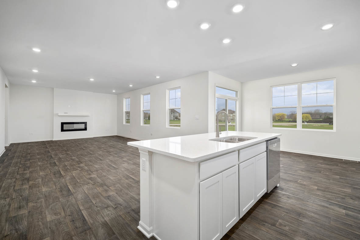 750 Kentshire Circle Elgin, IL 60124 - Photo 10 of 23 a large kitchen with kitchen island a sink wooden floor and a refrigerator
