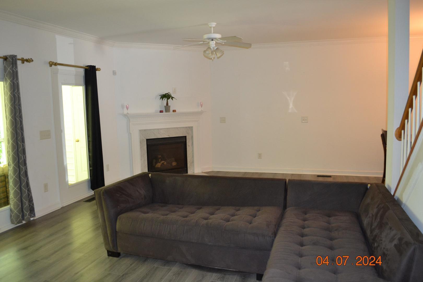 4506 Mistiflower Drive Raleigh, NC 27606 - Photo 21 of 27 a living room with furniture and a fireplace
