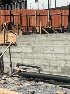 a view of swimming pool with lawn chairs and plants