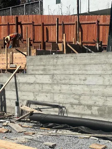 a view of swimming pool with lawn chairs and plants