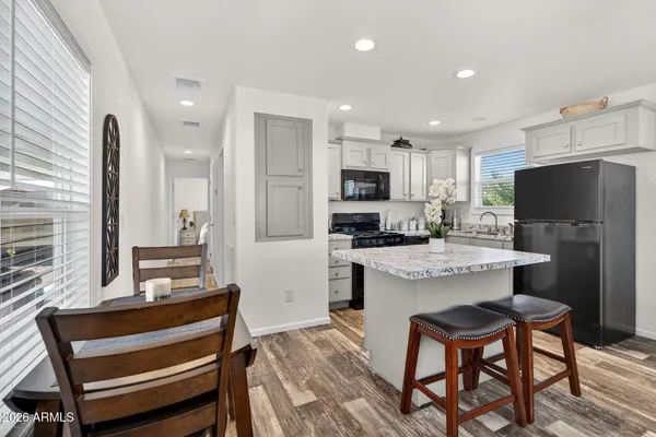 a kitchen with kitchen island a refrigerator stove microwave and cabinets