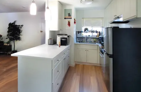 a kitchen with a refrigerator and a sink