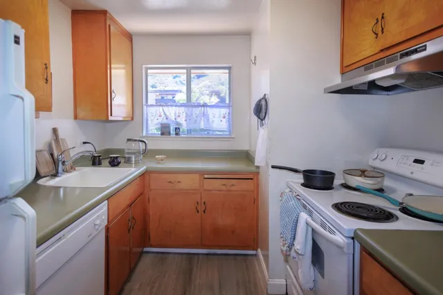 a kitchen with a sink stove and cabinets