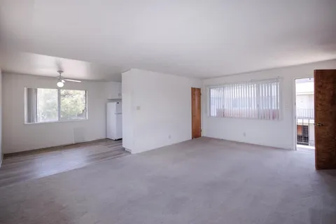 an empty room with windows and closet