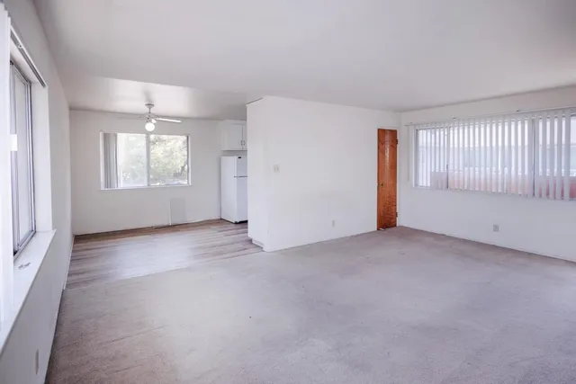 a kitchen with cabinets wooden floor and a window