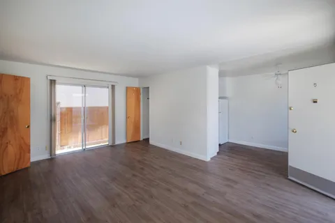 a large bed sitting in a bedroom next to a window
