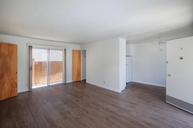 a large bed sitting in a bedroom next to a window