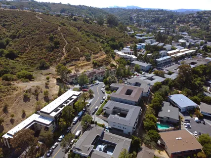 an aerial view of residential houses with outdoor space