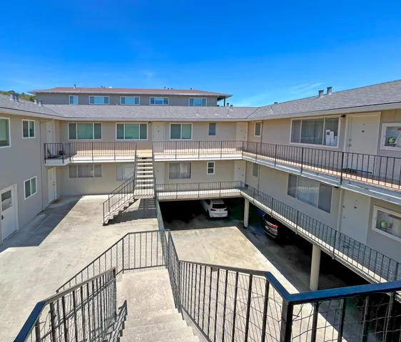 a view of a patio with table and chairs with wooden floor and fence