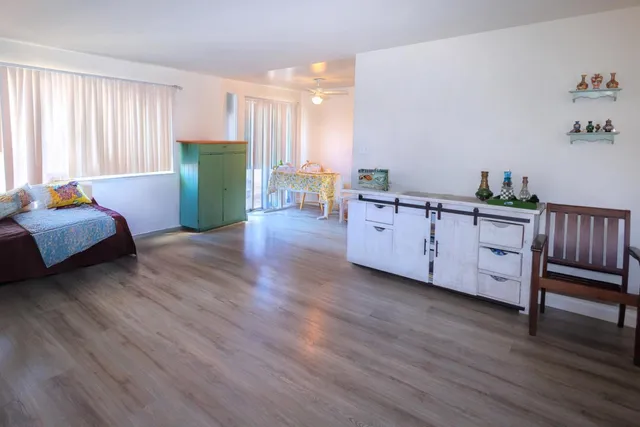 a living room with furniture and a wooden floor