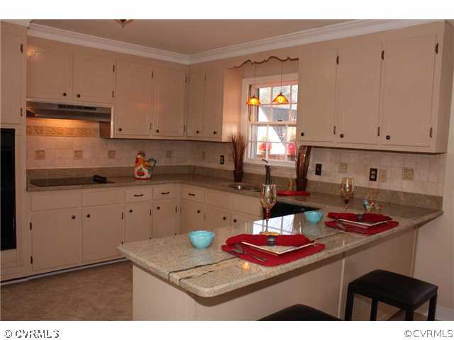 3008 Osborne Road Chester, VA 23831 - Photo 2 of 12 a kitchen with a stove and cabinets